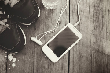 Sports shoes with smart phone and earphones and water bottle