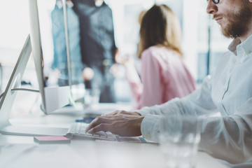 Project manager team work new idea.Young business crew working with startup modern loft.Desktop computer on table,typing keyboard presentation.Reflection monitor screen.Blurred,film effect.Horizontal.
