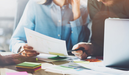 Photo team work process, signs contracts table. Account managers young crew works with startup project.New idea presentation, analyze marketing reports. Blurred, film effect, horizontal