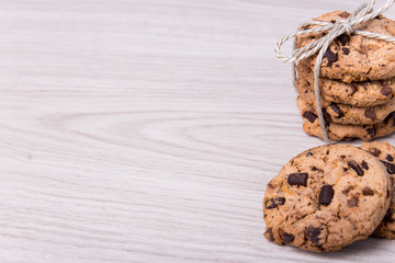 freshly baked chocolate chip cookies and copy space on wooden ba