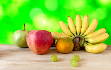 Fresh fruit apple grapes banana and grange with background