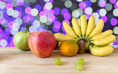 Fresh fruit apple grapes banana and grange with background
