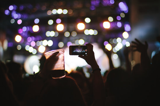 Close-up of a mobile phone recording a concert