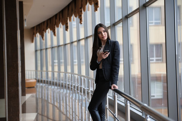 Young brunette woman is looking through the window on the planes