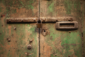 altes Türschloss an einer verwitterten Haustüre