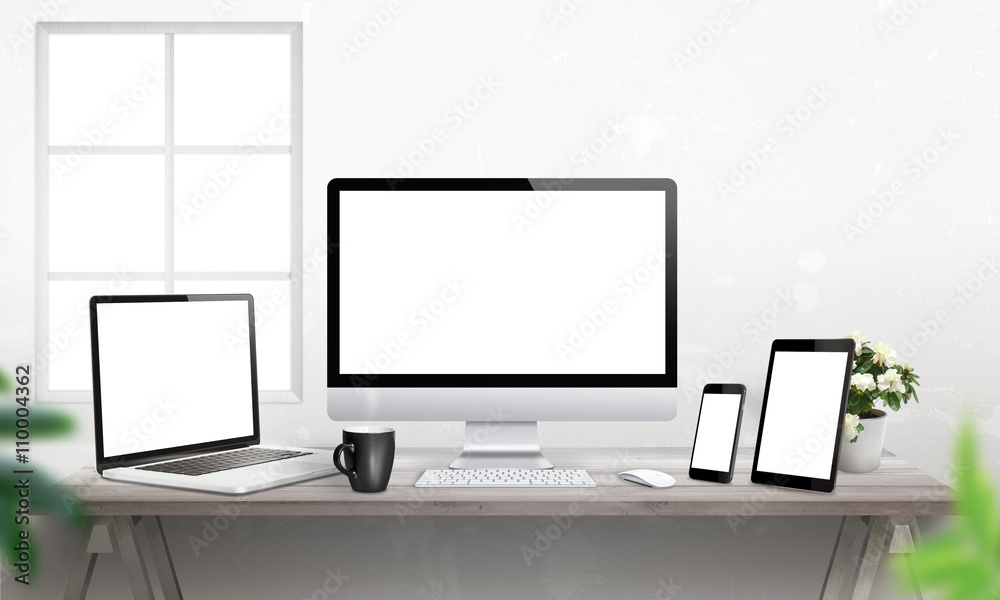 Aufkleber Responsive devices on desk with isolated screen for mockup. Computer display, laptop, tablet and smart phone. 