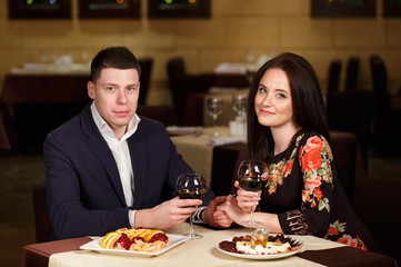 Couple toasting wineglasses in a luxury restaurant