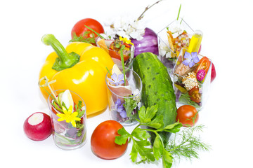 mini canapes in plastic cups decorated with edible flowers