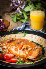 Potato pancakes with meat stew served on a plate.