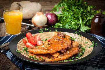 Potato pancakes with meat stew served on a plate.