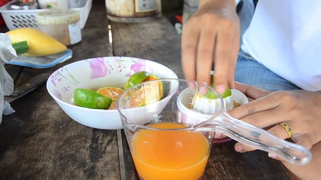 Made orange juice by fruit crush hand tool 
