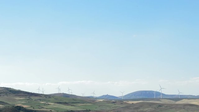 Wind turbines energy renewable at horizon at sunset