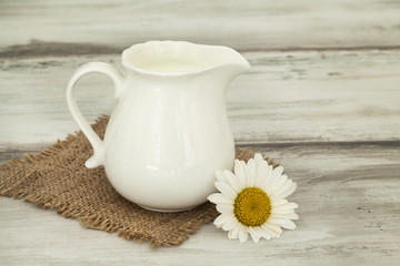 Jug of milk on wooden table