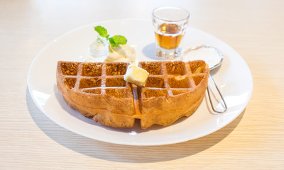 Waffle with maple syrup and butter