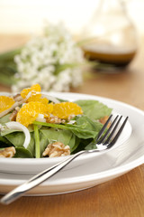 a plate of vegetable salad with slice oranges