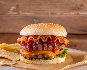 Bacon and cheese burger with grilled beef patty. tomato and onio