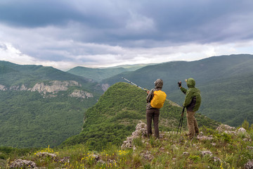Tourists with a camera in the mountains