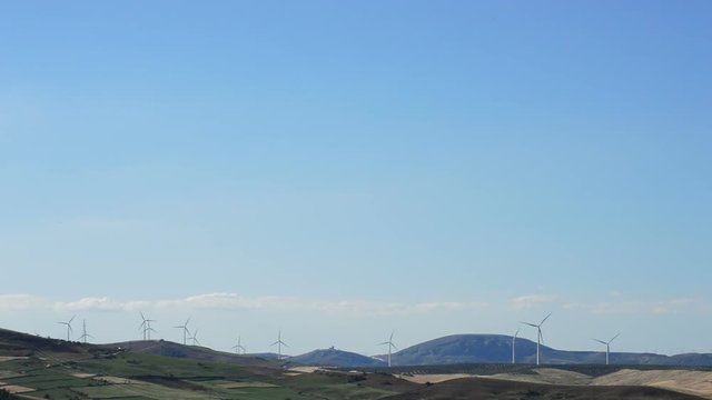 Landscape of wind turbines energy renewable at horizon at sunset