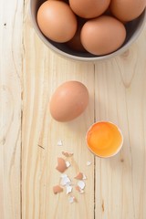 Fresh eggs on wood background. Top view