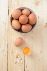 Fresh eggs on wood background. Top view