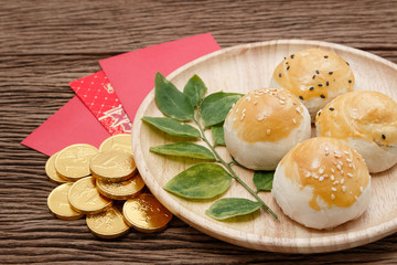 Chinese dessert with red envelope and gold ingots 