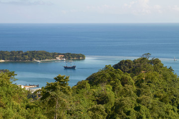Fototapeta na wymiar View of a Bay and laguna with a boat in Roatan in Honduras.