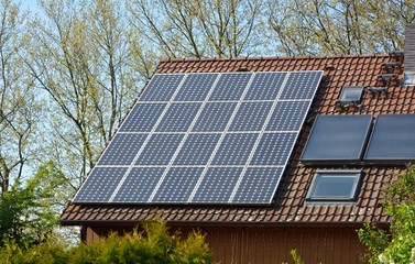 Naklejka premium Solar energy panels on roof of house