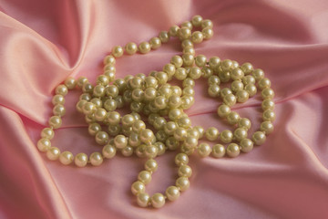 Pearl Necklace on delicate Pink silk background