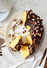 Bundt cake with chocolate glaze and pecan nuts top view