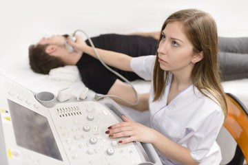 Man Being Checked for Thyroid at Ultrasound Device