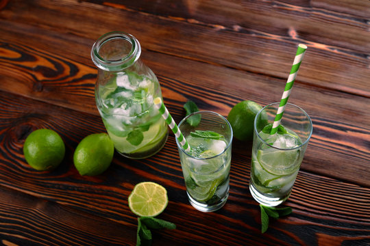 lemonade with lime and ice on a wooden background