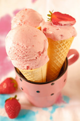 Three strawberry ice creams with fruit on colorful background