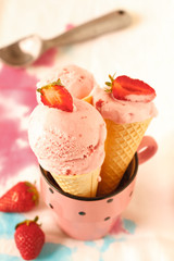 Three strawberry ice creams with fruit on colorful background