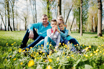 Happy pregnant family with two sons, dressed in a turquoise clot