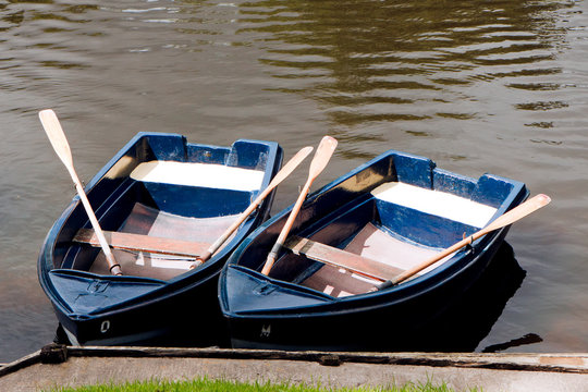 Two Rowing Boats With Oars Moored On The River Coquet