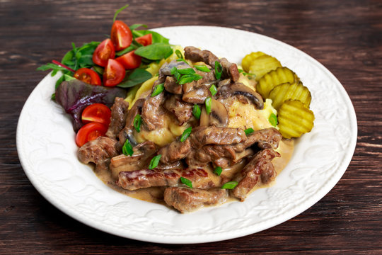 Beef Stroganoff with mashed potatoes and some vegetables.