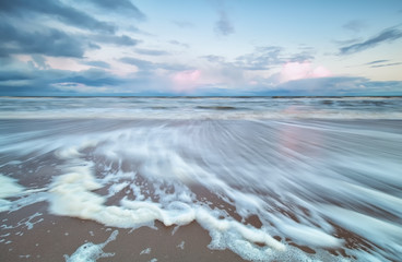 blurred North sea wave at sunrise