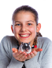 Cute girl holding a hamster