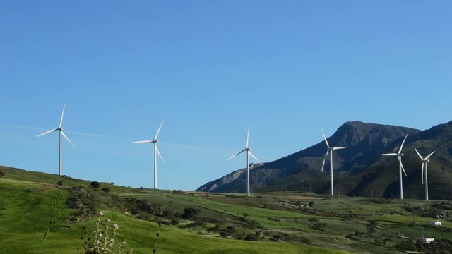 Landscape of wind turbines energy moving in the mountains at sunny day