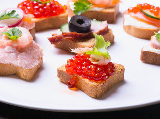 Small sandwiches on wooden background