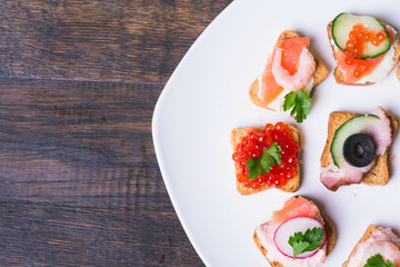 Small sandwiches on wooden background
