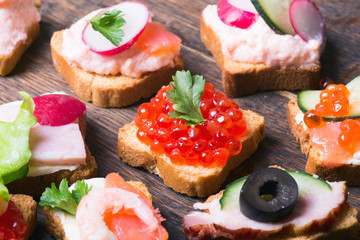 Small sandwiches on wooden background