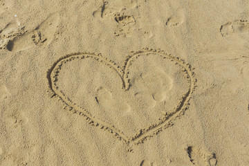 Heart drawn in the sand of the beach. Love concept.