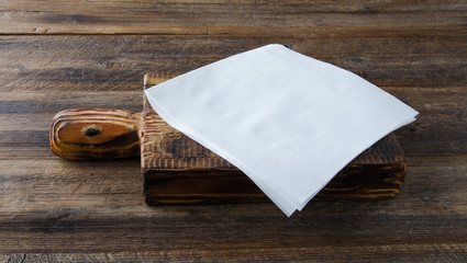 Napkin on wooden table. Top view.
