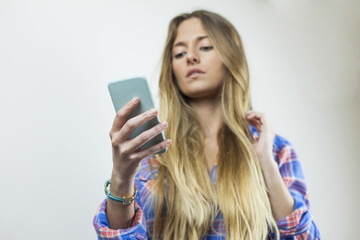 Close up portrait of beautiful blonde woman with plaid shirt sen © Susana Valera
