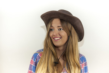 Portrait of beautiful blonde woman with plaid shirt and a cowboy