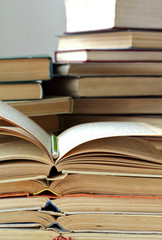 stacks of old opened books and pencil, closeup view