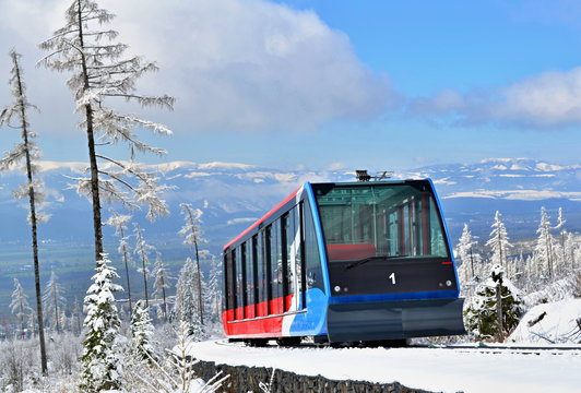 Cableway cabin on rails in mountains