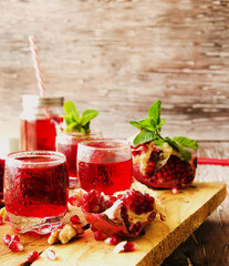 Fresh pomegranates and juice, selective focus