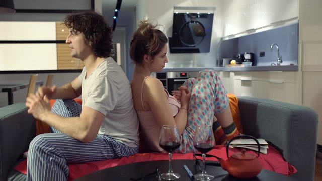 Couple leaning on ech other and sitting in silence after argument

